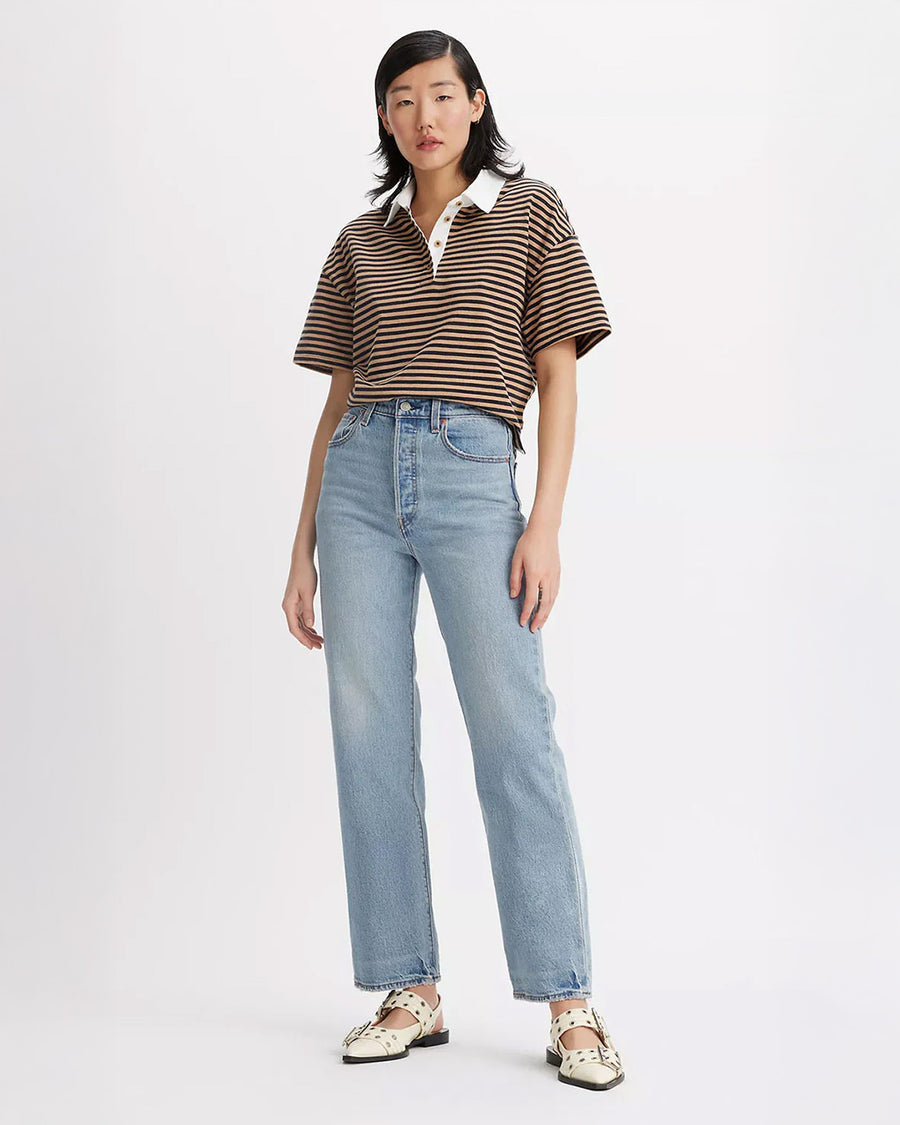 model wearing light wash ribcage straight ankle jeans