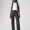 model wearing washed black relaxed fit straight leg jeans and white tee