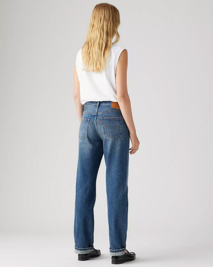 back view of model wearing medium wash 90's selvedge jeans