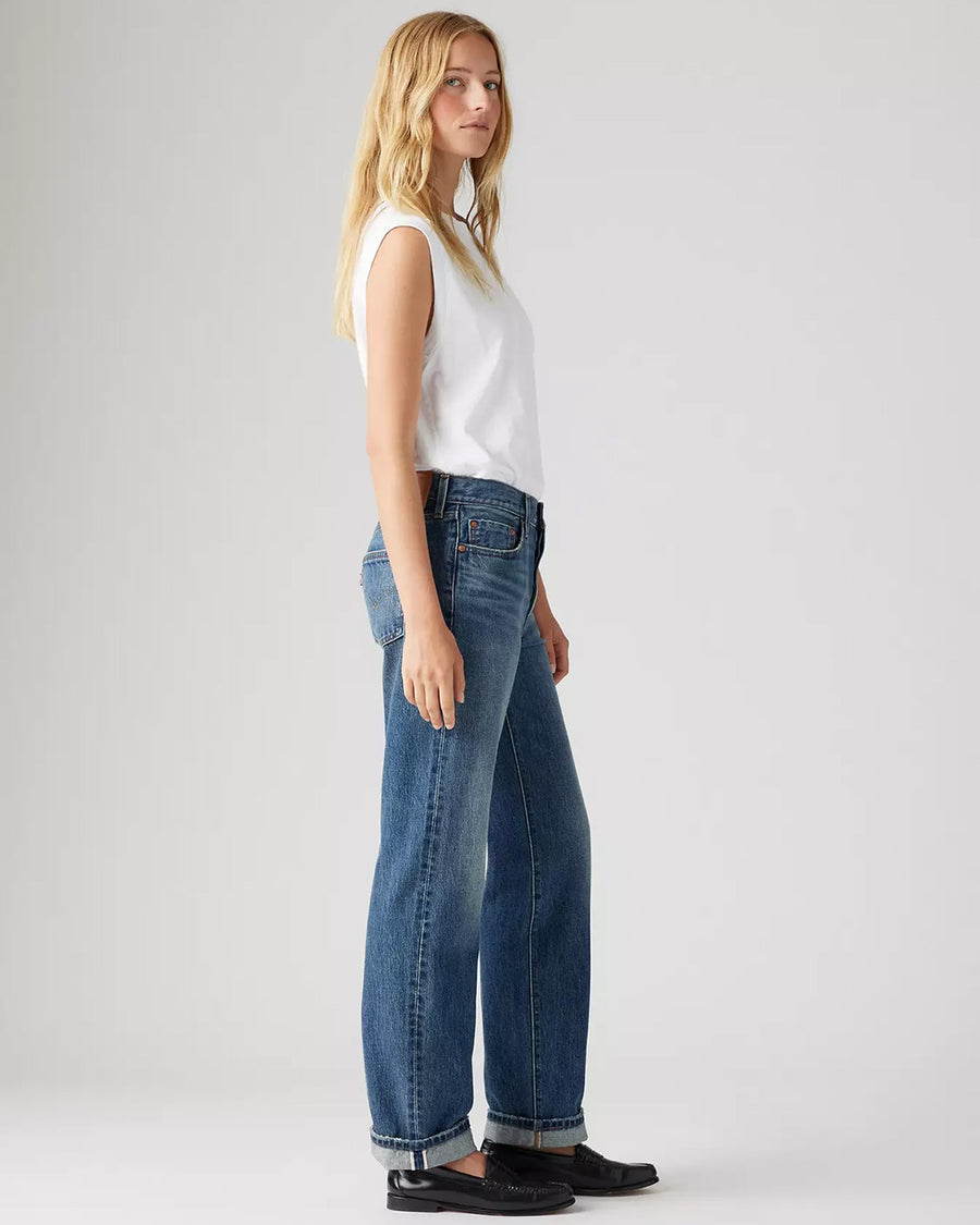 side view of model wearing medium wash 90's selvedge jeans