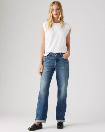 model wearing medium wash 90's selvedge jeans