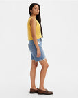 sideview of model wearing distressed relaxed fit shorts