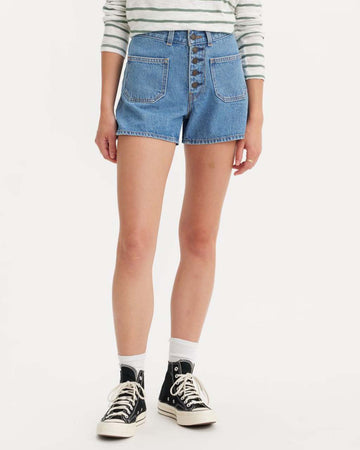 model wearing light denim patch pocket shorts