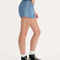 side view of model wearing light denim patch pocket shorts