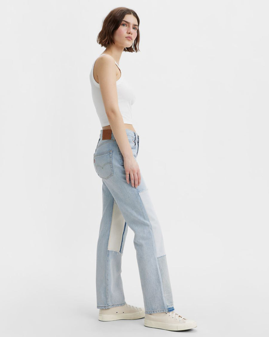 sideview of model wearing light and medium color patchwork denim jeans