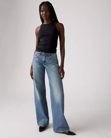 model wearing light denim low loose jeans