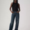 model wearing low rise dark wash denim with a relaxed leg