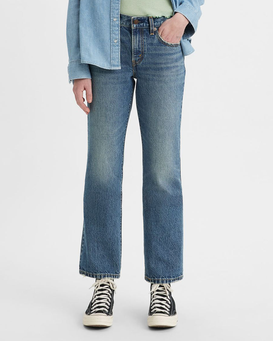 model wearing relaxed medium denim jeans