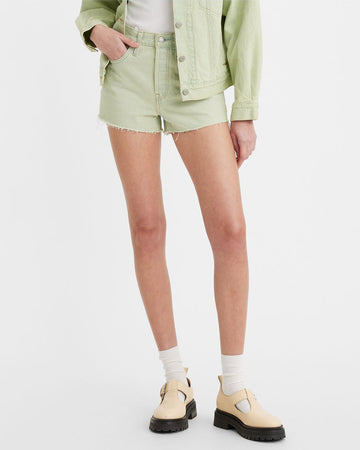 model wearing green raw hem shorts