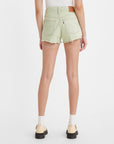 backview of model wearing green raw hem shorts
