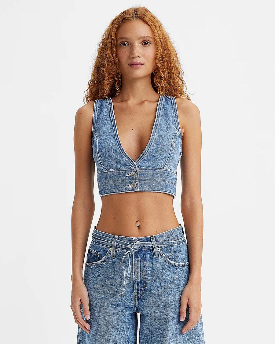 model wearing cropped denim sleeves top with deep V neckline and two button closure