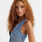 up close of model wearing cropped denim sleeves top with deep V neckline and two button closure