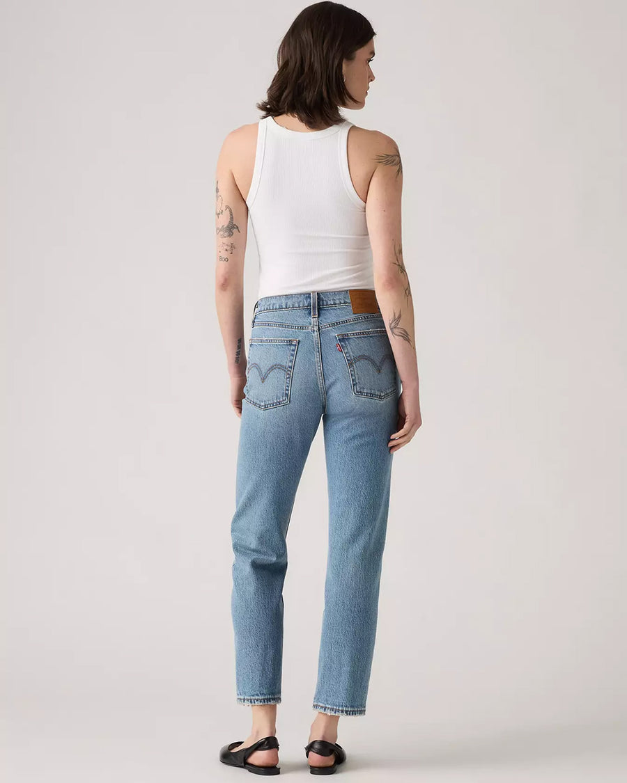 back view of model wearing light denim wedgie straight jeans