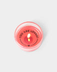 lit candle with message 'you are loved' on the bottom