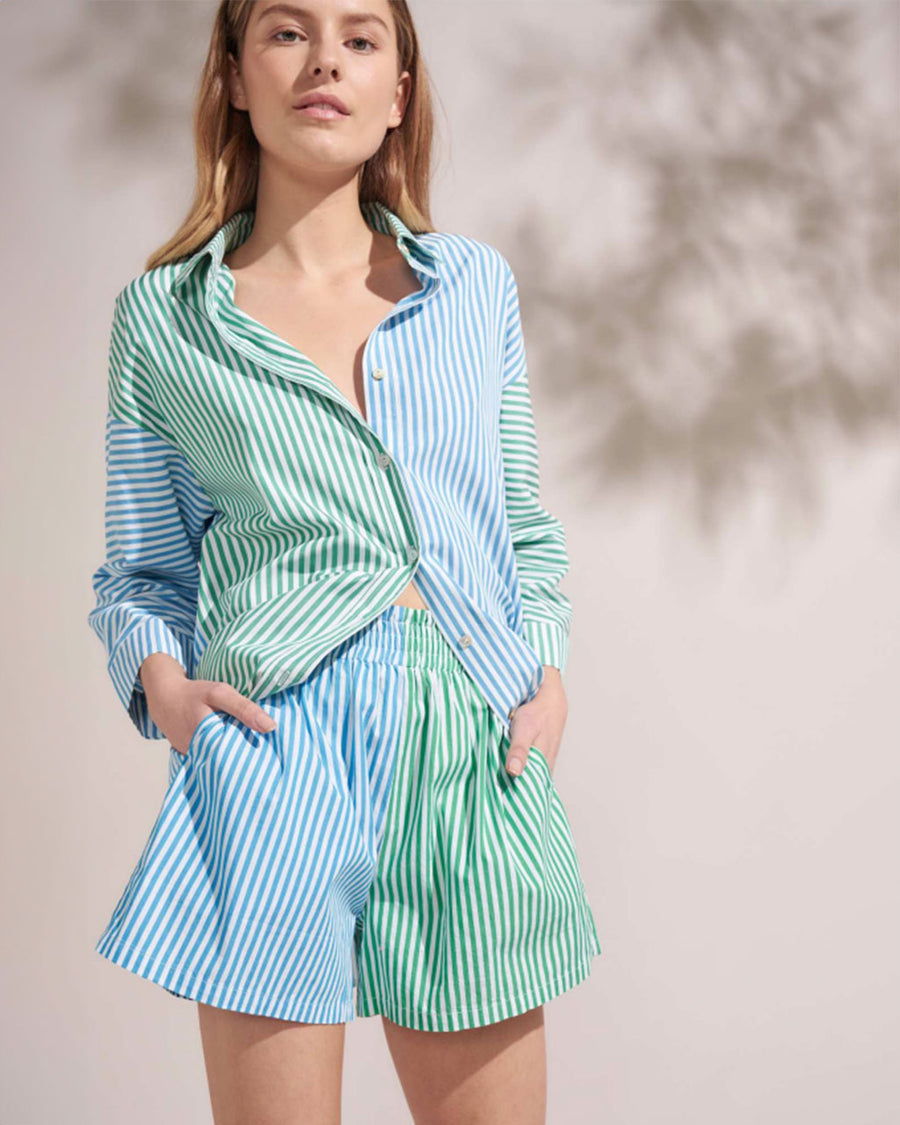 model wearing blue and green contrasting stripe top and matching shorts