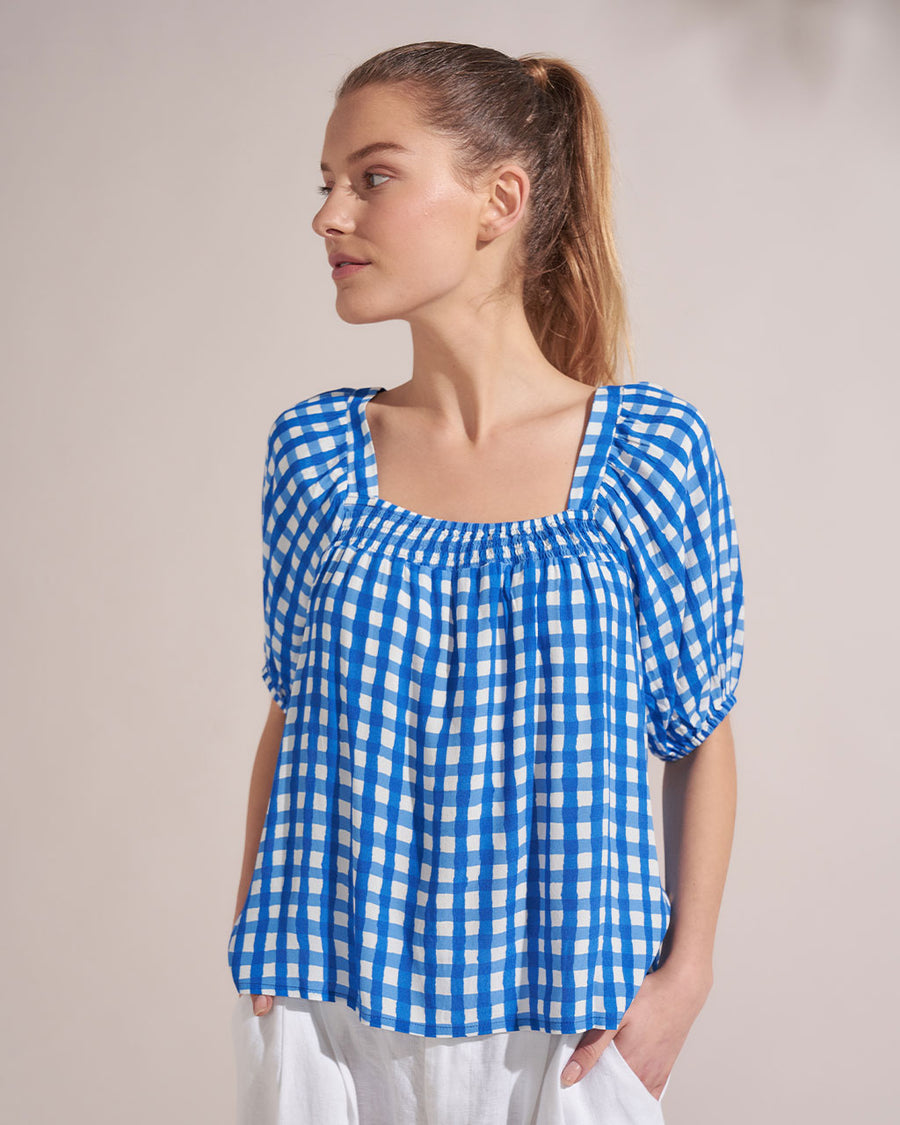 model wearing sqaure neck top with blue and white gingham print