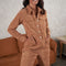 model wearing copper cord jumpstio with long sleeves, oversized buttons and patch front pockets