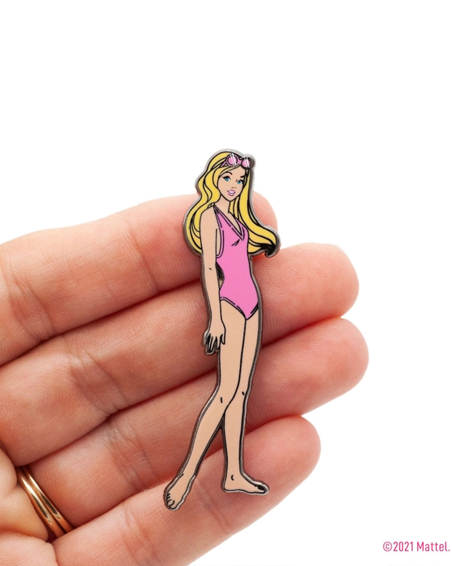 model holding malibu beach barbie with pink swimsuit pin