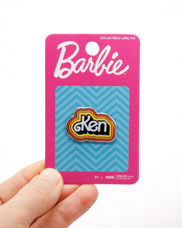 model holding retro color 'Ken' pin on packaging