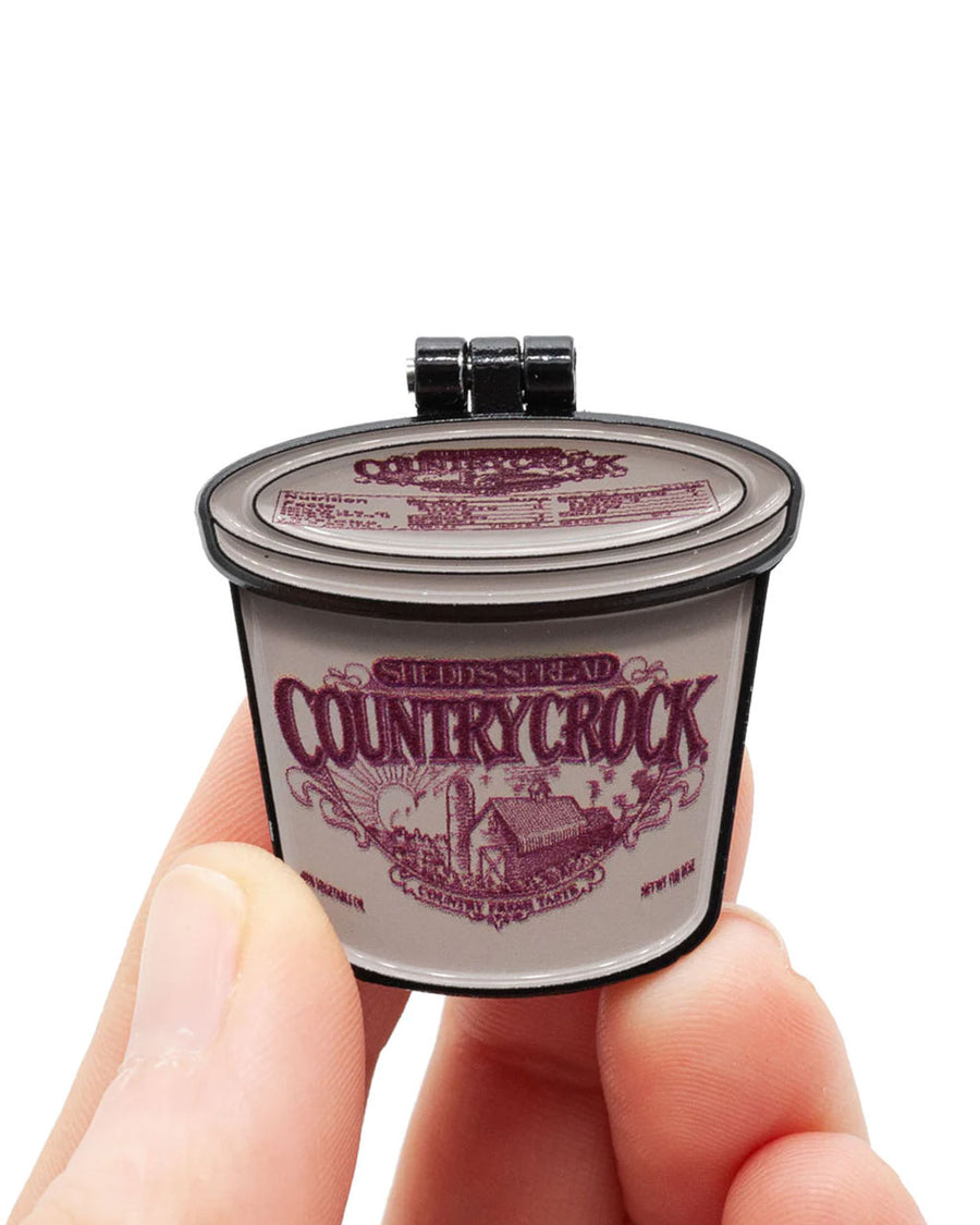 model holding country crock pin with hinged lid and spaghetti and meatballs inside