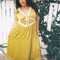 model wearing chartreuse midi dress with white lace accents on the bust, two tie front and ruffle detail on the shoulders
