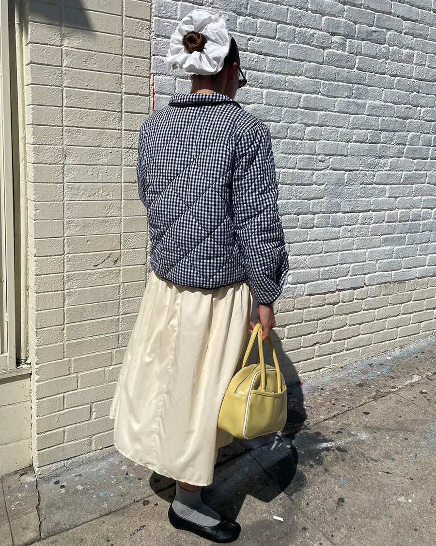 back view of model wearing blue checkered jacket with blue plaid front patch pockets and collar