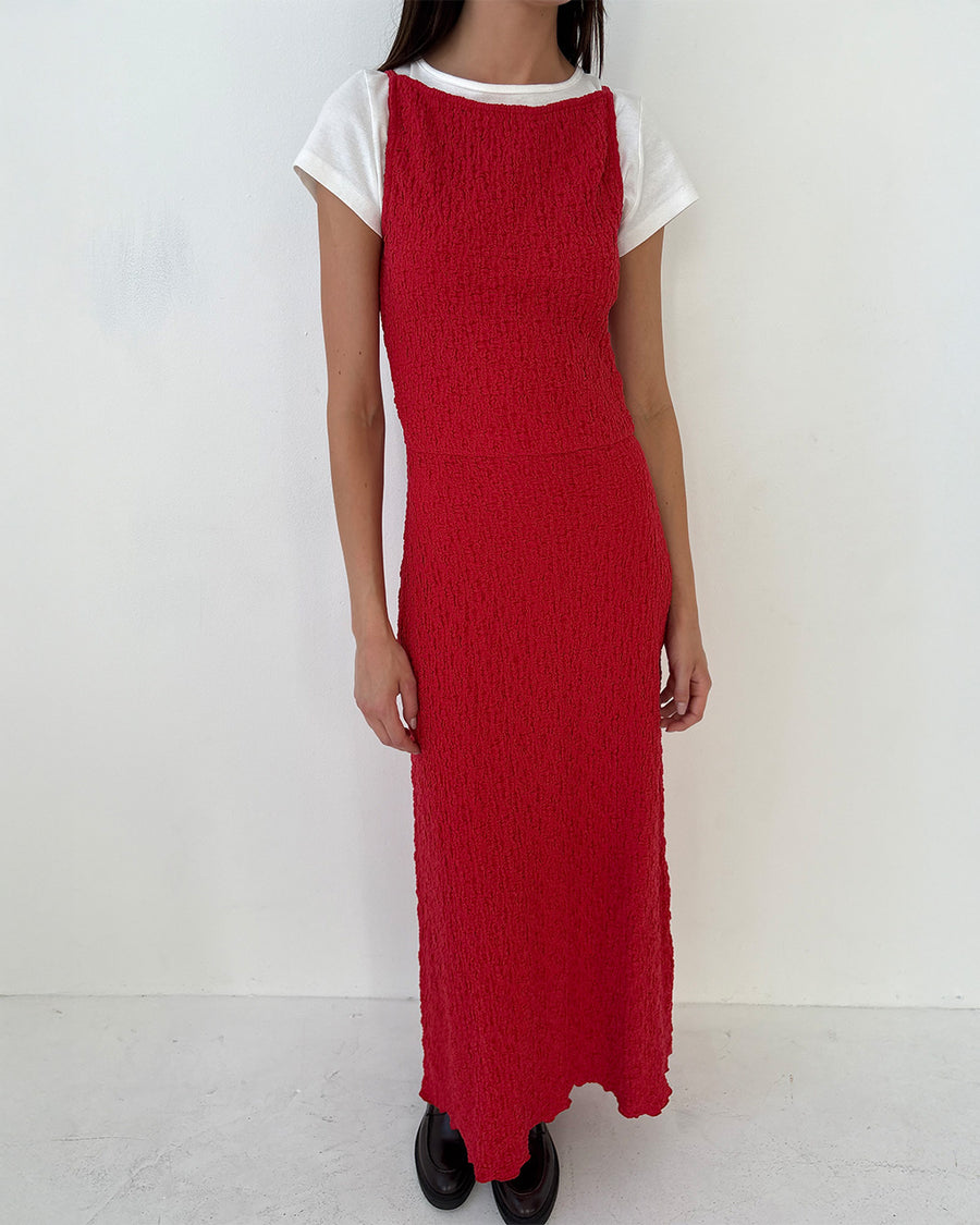 model wearing pepper red crinkle tank maxi dress with open tie back wearing a white tee underneath