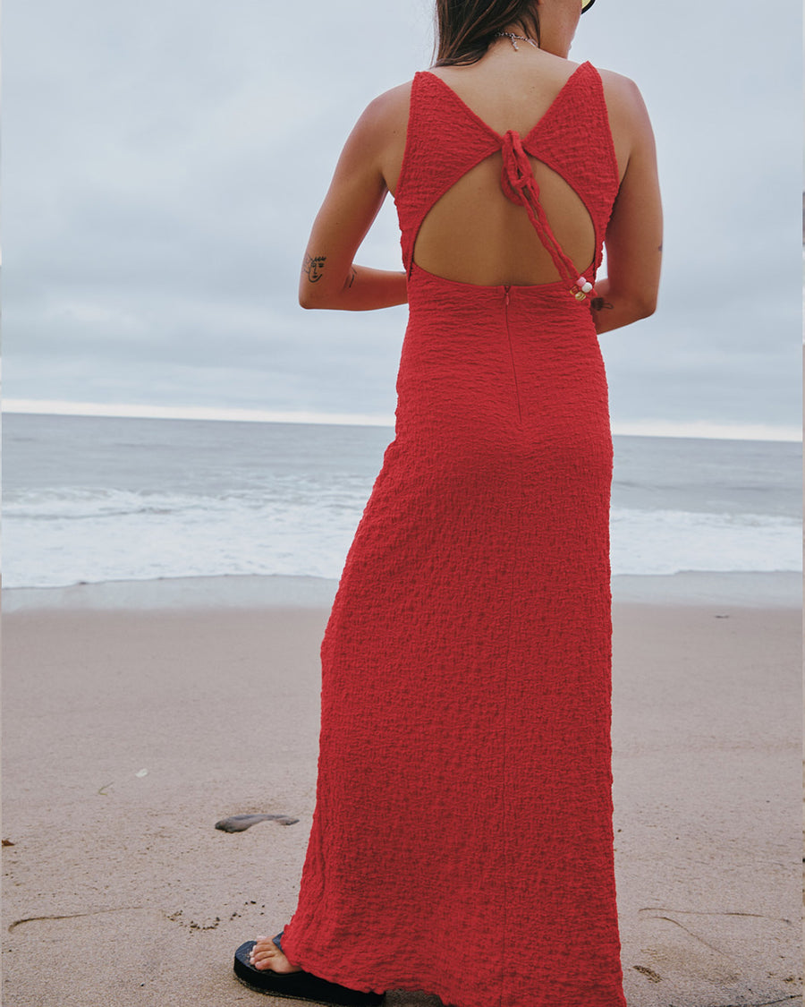 back view of model wearing pepper red crinkle tank maxi dress with open tie back