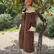model wearing brown oversized trench coat with white and dainty blue folk print tie shawl, arm and hem trim