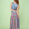 back view of model wearing colorful plaid midi skirt with drop waist