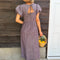 back view of model wearing brown striped midi dress with puff sleeves, v-waistline and tie back