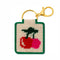 completed tan needlepoint keychain kit with green trim and red and pink cherry print and gold hardware