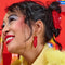 model wearing red 'sweetish' fish shaped dangle earrings on gold hoops 