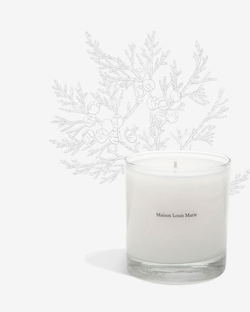 The Le Long Fond candle by Maison Louis Marie is white and comes in a clear glass tumbler.
