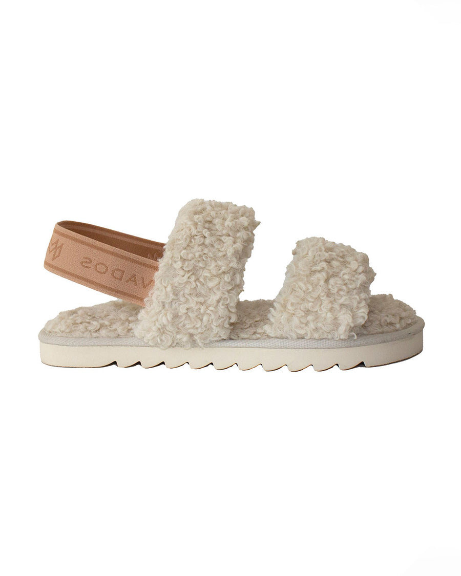 side view of tan faux fur slipper sandal with brown elastic strap