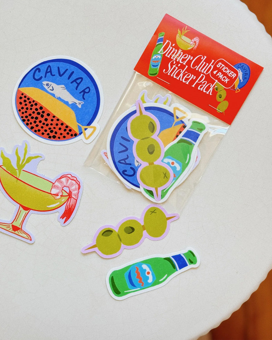 set of 4 deli stickers: dill pickle spear, everything bagel with lox, a slice of cheese and a coffee in a disposable cup on a table