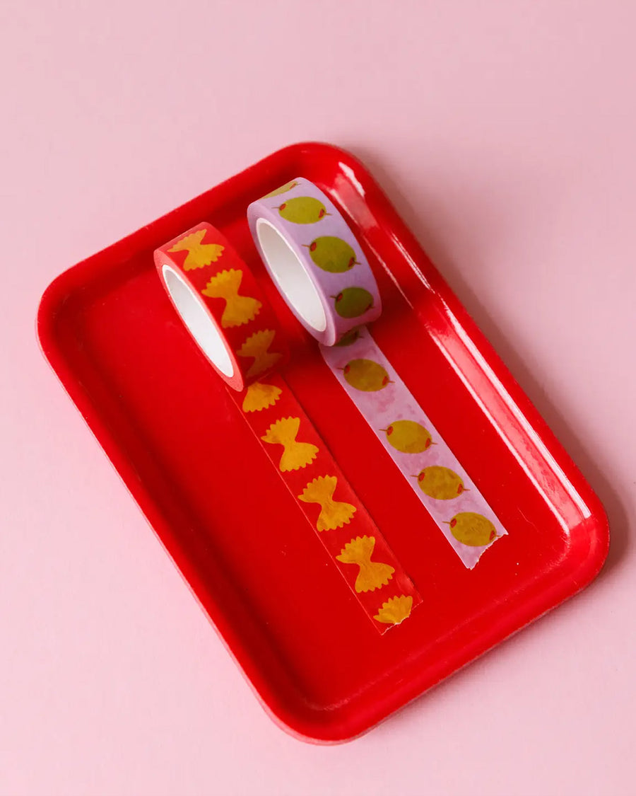 set of two rolls of washi tape: pink tape with olives, and red with bowtie pasta on a red tray