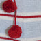 up close of grey cotton stocking with red and white thin stripes, red trim on the cuff and red pom pom detail