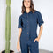 up close of model wearing dark blue short sleeve jumpsuit with cinched waist and button front