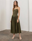 model wearing olive green midi dress with boned corset bodice and two sets of straps