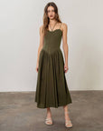 model wearing olive green midi dress with boned corset bodice and two sets of straps