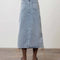back view of model wearing light denim midi skirt with brown side tie details
