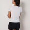 back view of model wearing white cotton short sleeve blouse with deep v-neck, button front and corset waist and black shorts