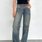 model wearing blueish-green low rise wide leg denim