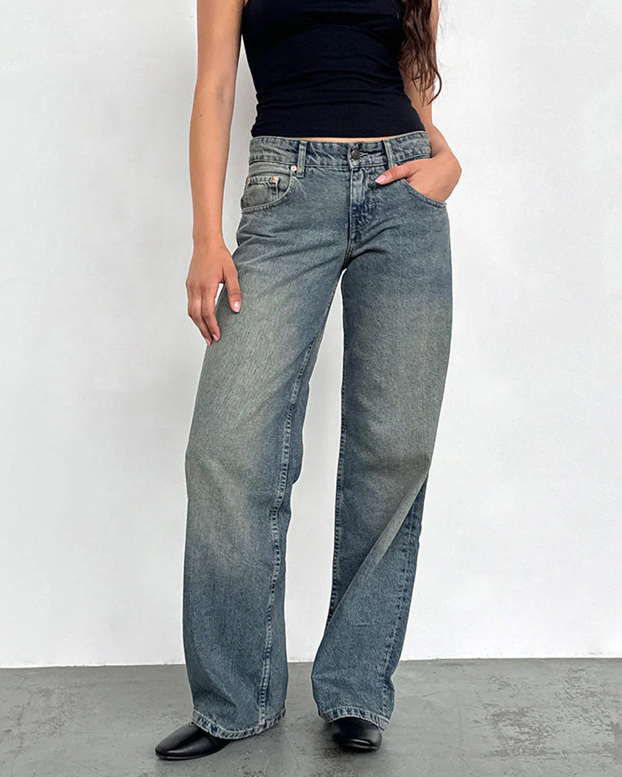 model wearing blueish-green low rise wide leg denim