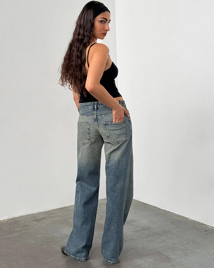 back view of model wearing blueish-green low rise wide leg denim