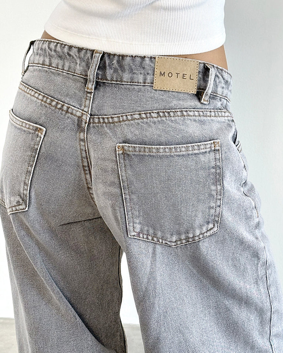 up close of back of light grey low rise wide leg denim and white tank