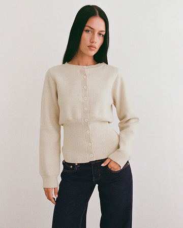 model wearing ivory cardigan with cinched in waist