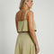 back view of model wearing moss cropped linen tank with ruffle bust detail and matching midi skirt