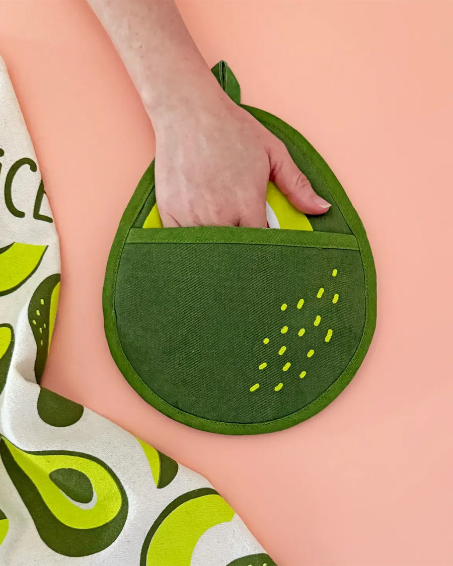 model putting hand in avocado pocket pot holder
